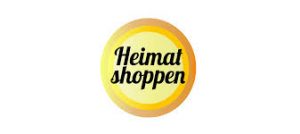 Ein kreisförmiges Logo mit den Worten „Heimat shoppen“ in stilisierter schwarzer Schrift auf gelbem Hintergrund. Der Kreis hat einen Farbverlauf von Gelb nach Orange und bietet Links und Informationen. Der Hintergrund des Bildes ist weiß.